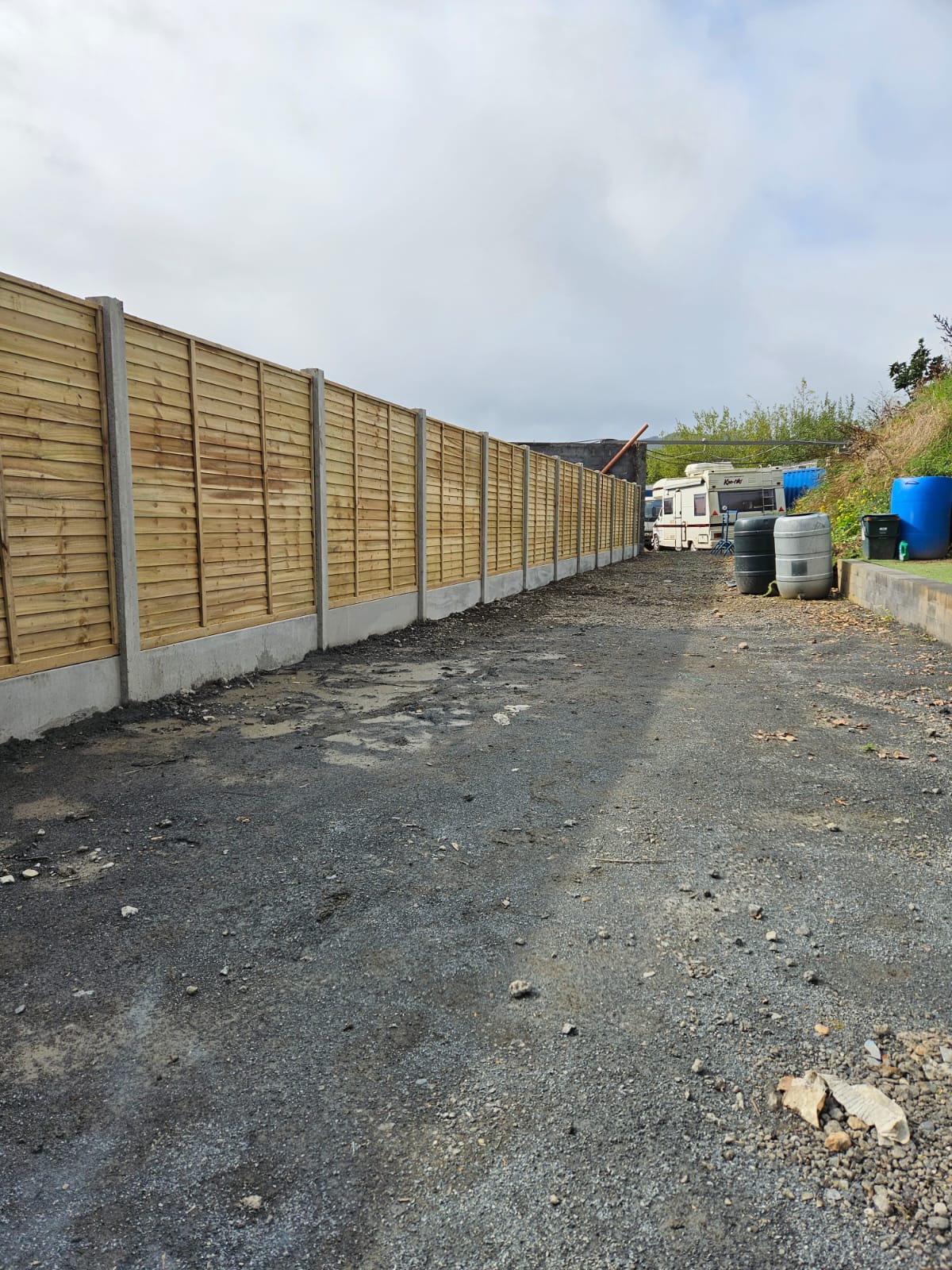 Long hand built garden fence and posts